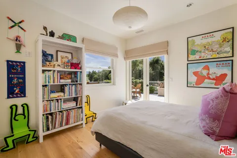 a spacious bedroom with a bed and a dresser