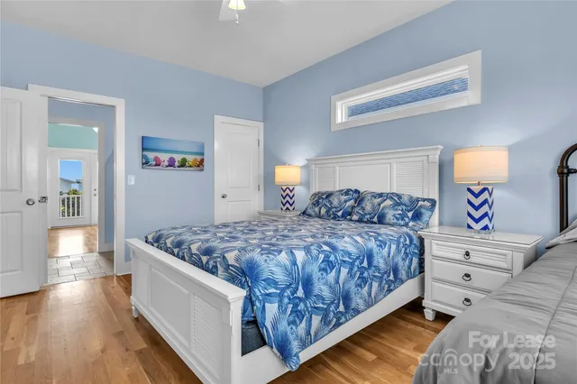 a bathroom with a granite countertop sink vanity mirror and toilet