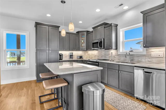 a kitchen with a sink a counter space and appliances