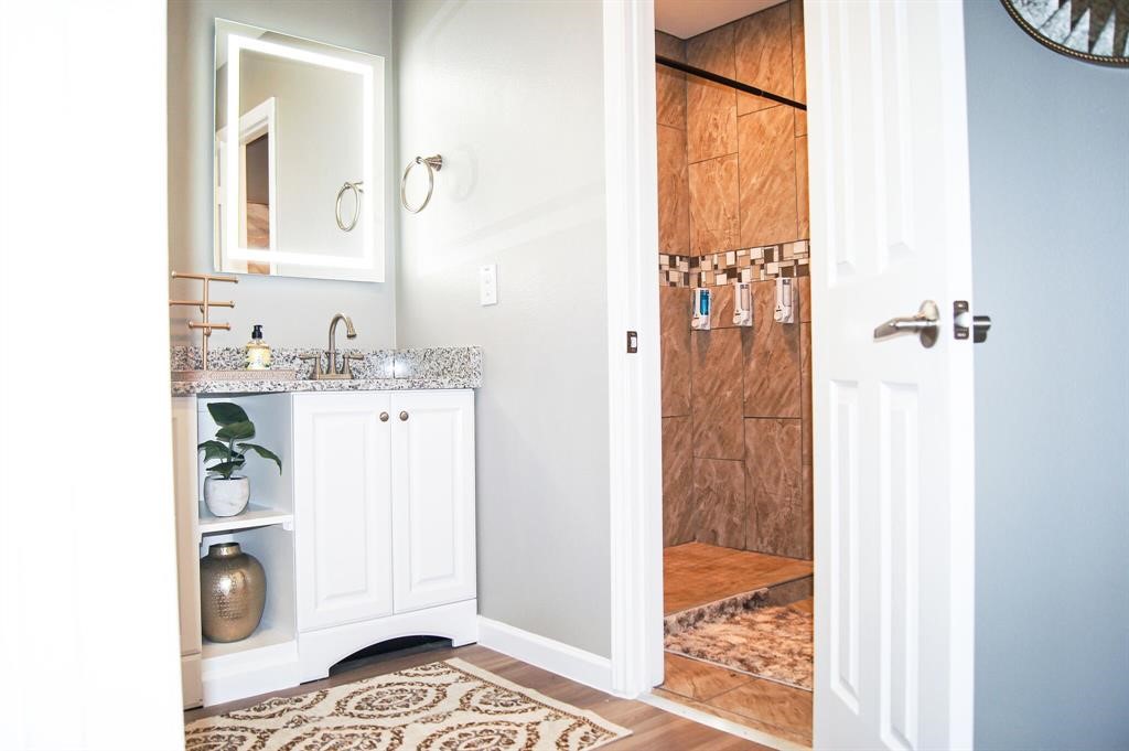 1727 Pueblo Street Dallas, TX 75212 - Photo 21 of 27 a bathroom with a sink a mirror and a shower