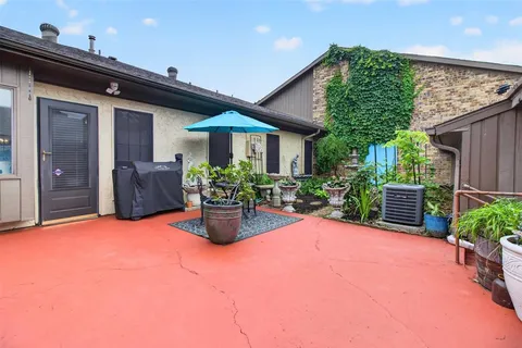 a view of a house with patio and garden