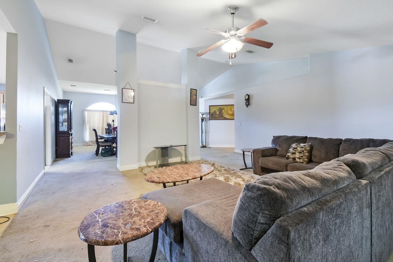 46 Riddle Drive Palm Coast, FL 32164 - Photo 3 of 20 a living room with furniture and a chandelier