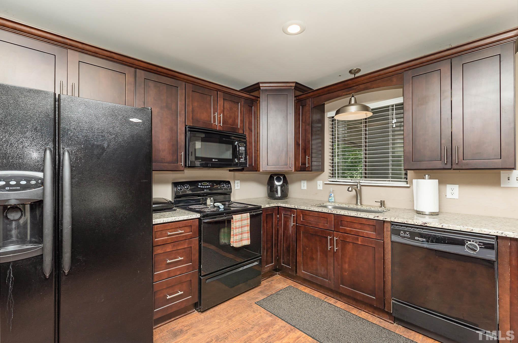 5609 Roslyn Road Durham, NC 27712 - Photo 14 of 31 a kitchen with a sink stove and refrigerator