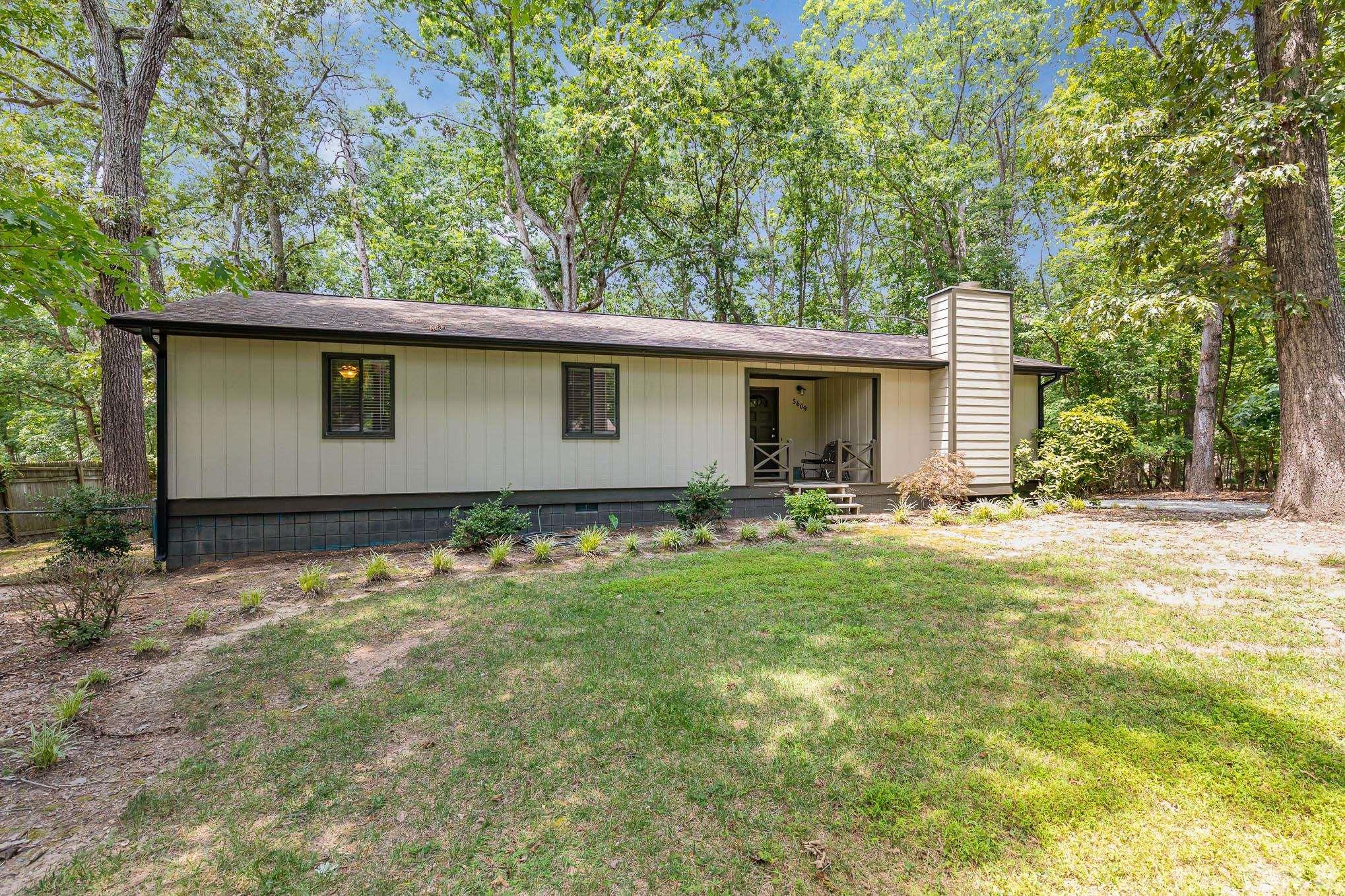5609 Roslyn Road Durham, NC 27712 - Photo 2 of 31 a backyard of a house with table and chairs