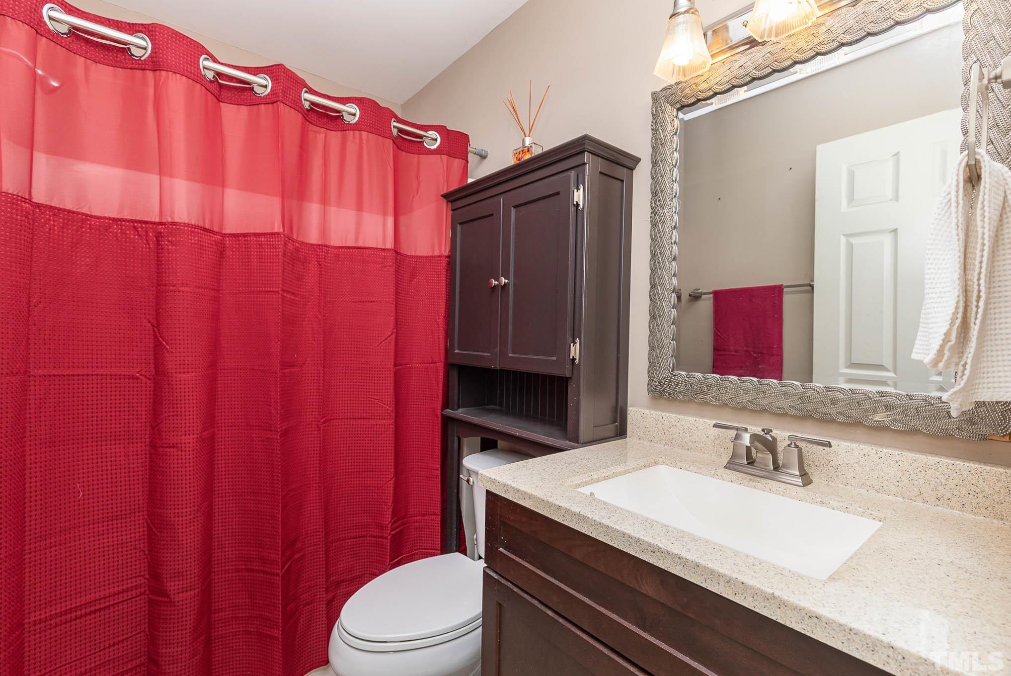 5609 Roslyn Road Durham, NC 27712 - Photo 22 of 31 a bathroom with a sink a toilet and shower