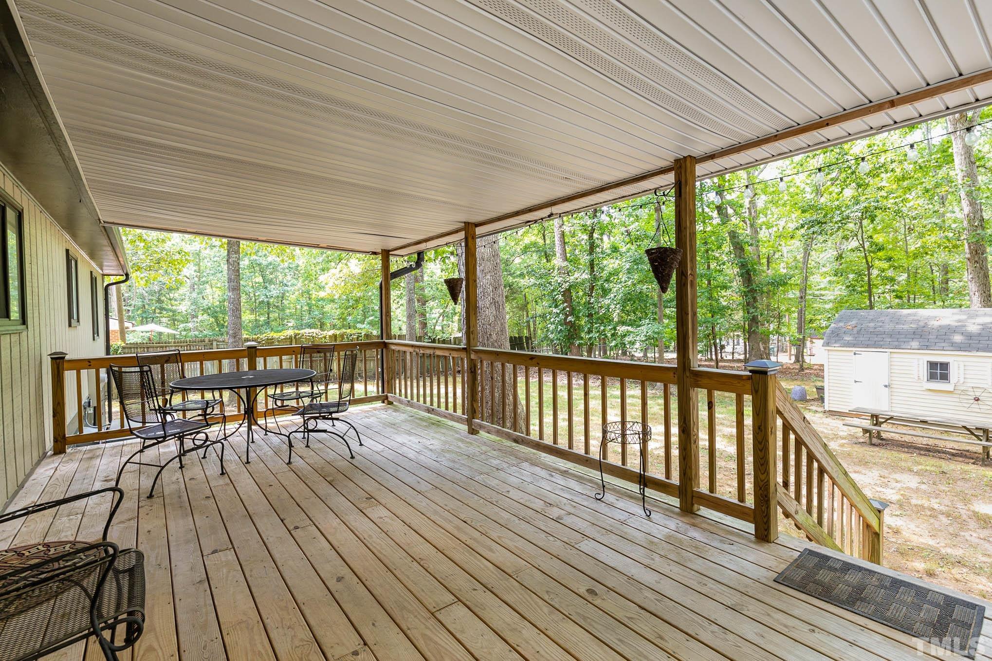 5609 Roslyn Road Durham, NC 27712 - Photo 23 of 31 a view of a balcony with chairs and wooden floor