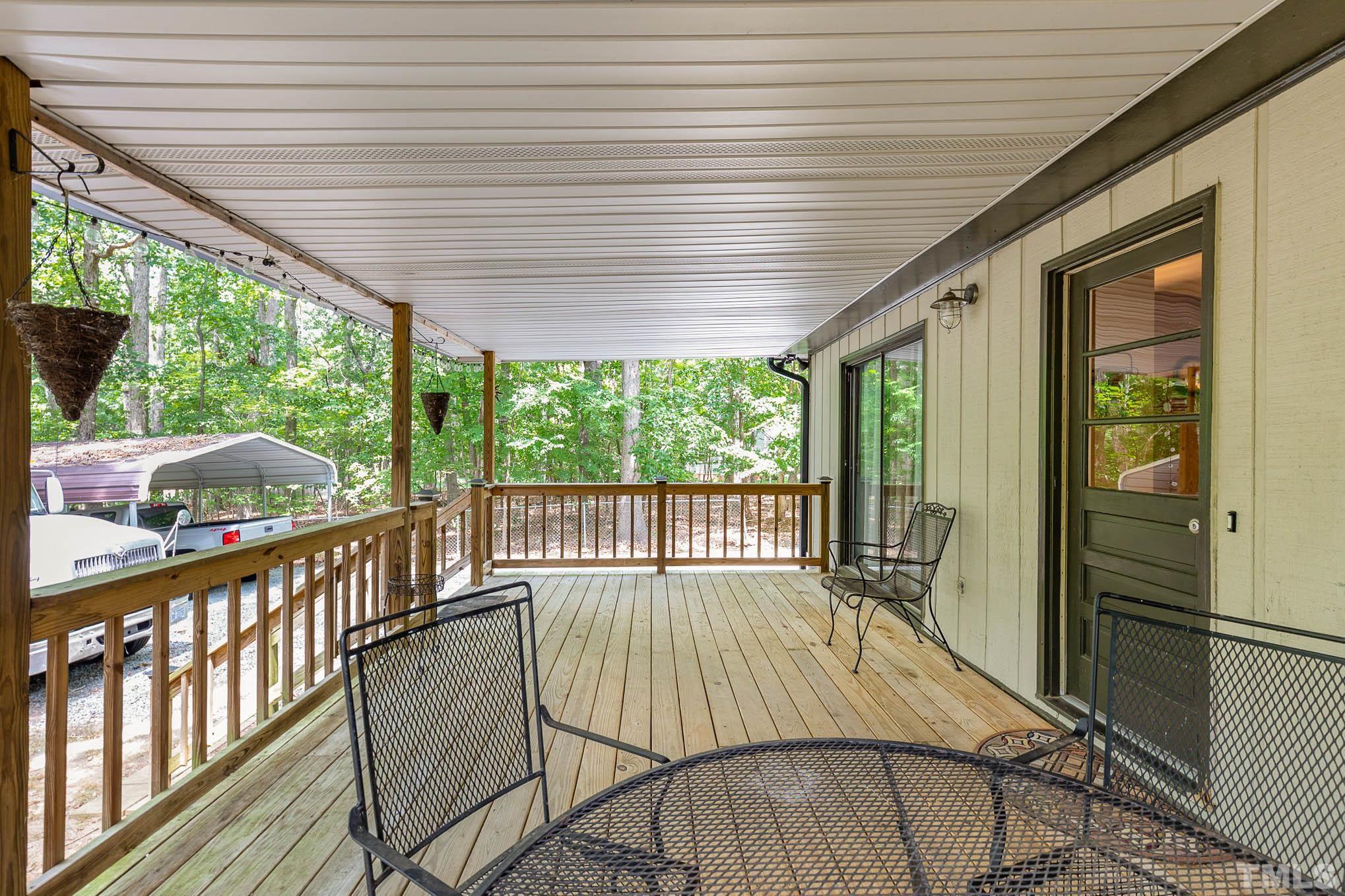 5609 Roslyn Road Durham, NC 27712 - Photo 24 of 31 a balcony with furniture and wooden floor