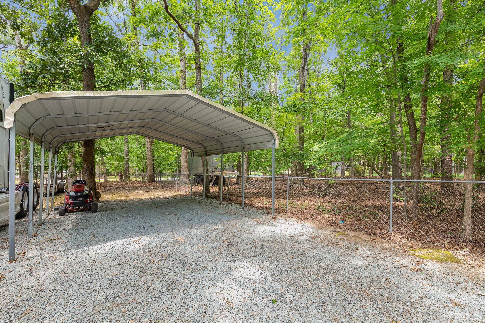 5609 Roslyn Road Durham, NC 27712 - Photo 26 of 31 a view of a patio with a table and chairs under an umbrella