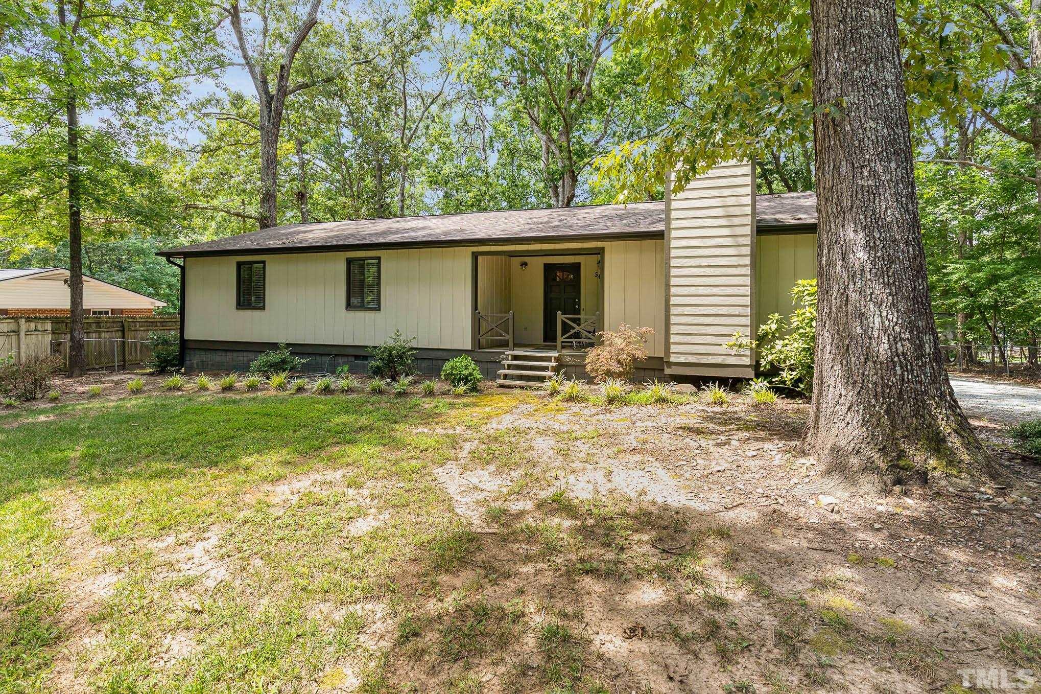 5609 Roslyn Road Durham, NC 27712 - Photo 3 of 31 a backyard of a house with yard and outdoor seating