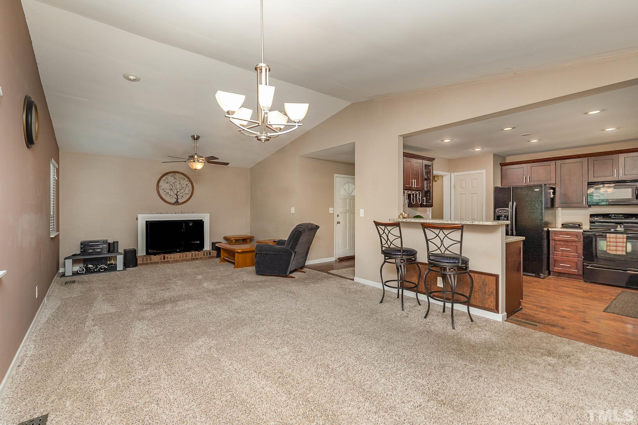 5609 Roslyn Road Durham, NC 27712 - Photo 7 of 31 a view of a livingroom with furniture and a fireplace