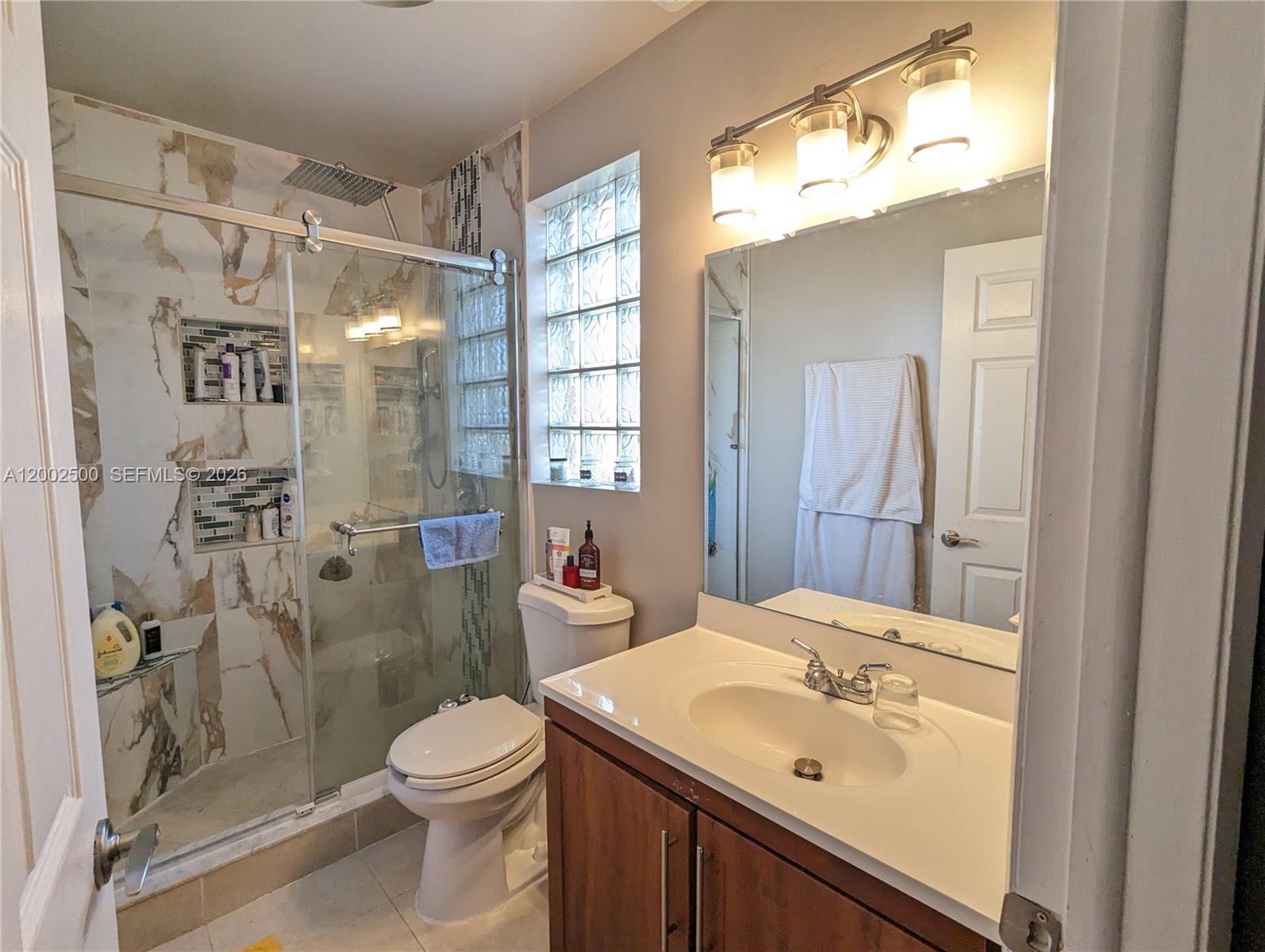 12328 Southwest 251st Terrace Homestead, FL 33032 - Photo 19 of 22 a bathroom with a sink a toilet and shower