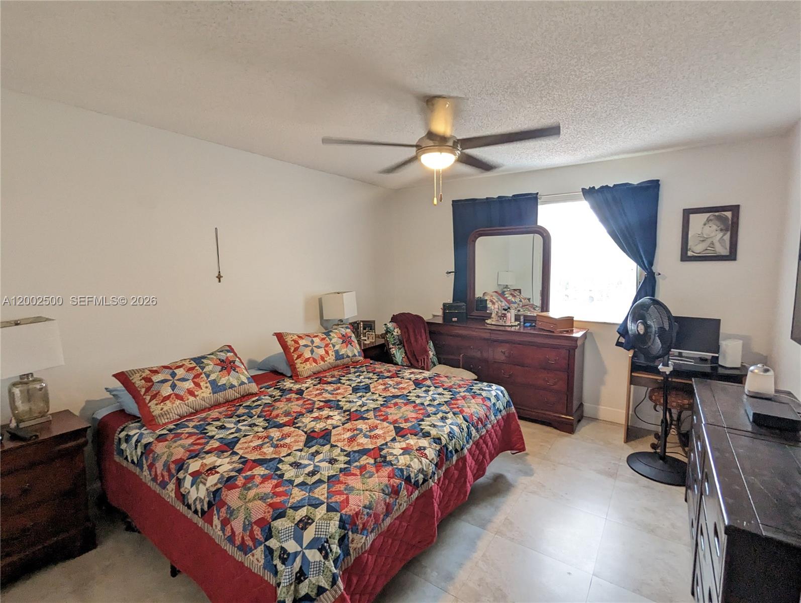 12328 Southwest 251st Terrace Homestead, FL 33032 - Photo 20 of 22 a bedroom with a bed and dresser with mirror