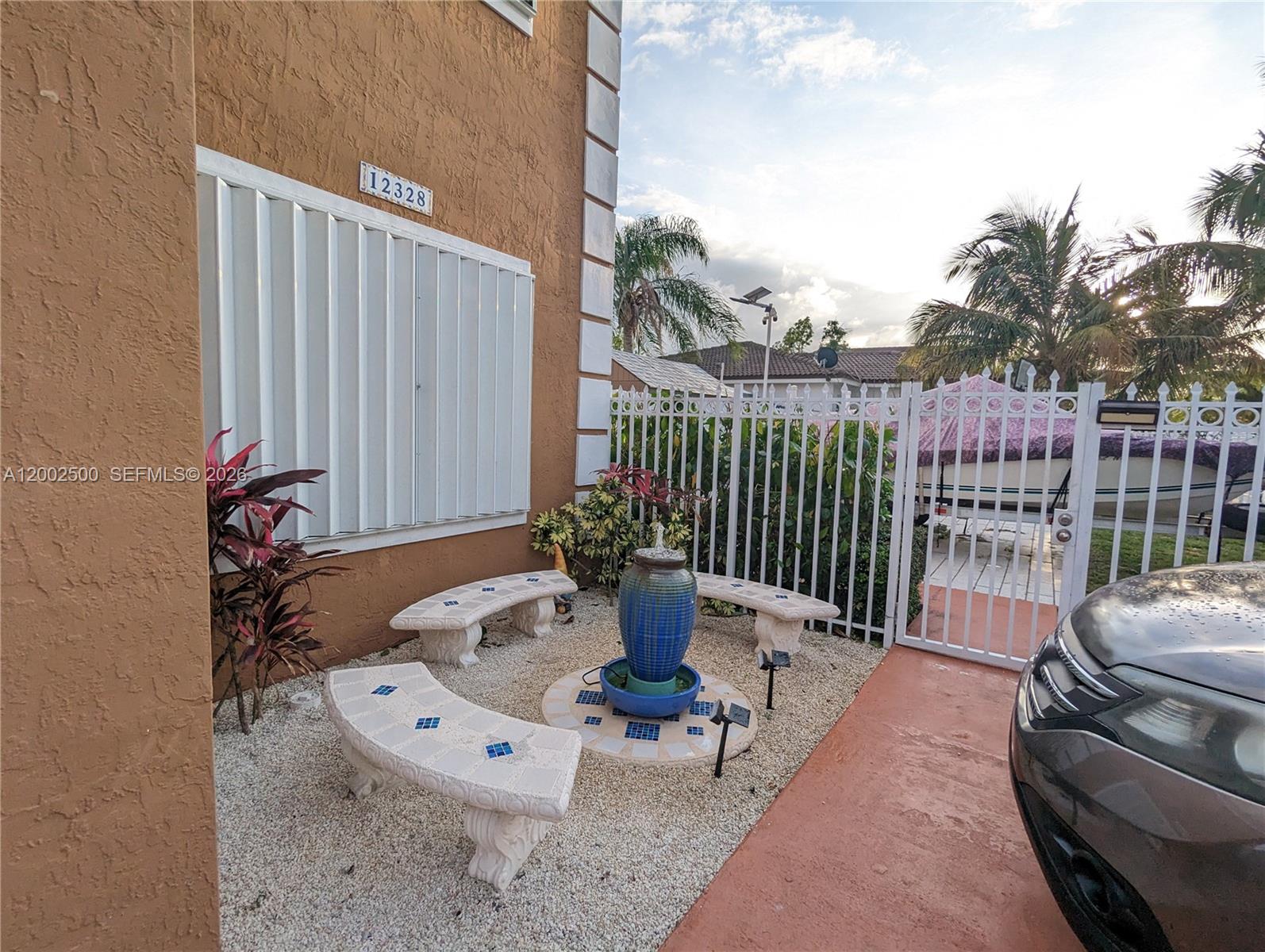 12328 Southwest 251st Terrace Homestead, FL 33032 - Photo 3 of 22 a view of a patio with couches table and chairs and potted plants