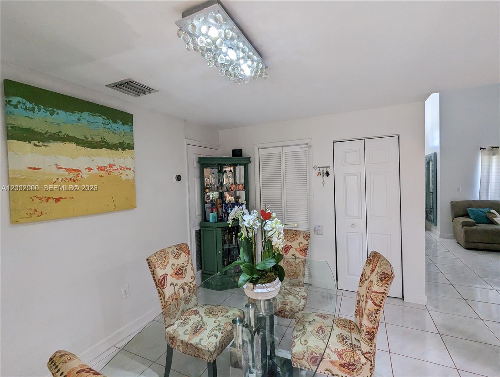 12328 Southwest 251st Terrace Homestead, FL 33032 - Photo 7 of 22 a view of a dining room with furniture and chandelier