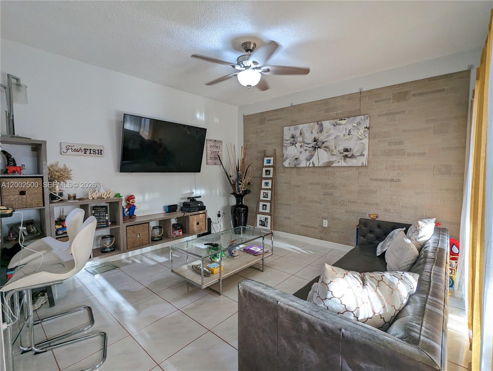12328 Southwest 251st Terrace Homestead, FL 33032 - Photo 8 of 22 a living room with furniture and a flat screen tv