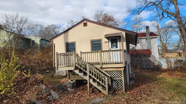 a view of a house with a yard and sitting area