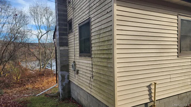 a view of a back yard and tree
