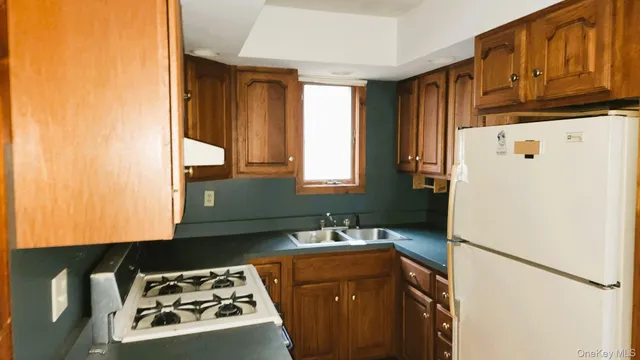 a kitchen with a refrigerator and a sink
