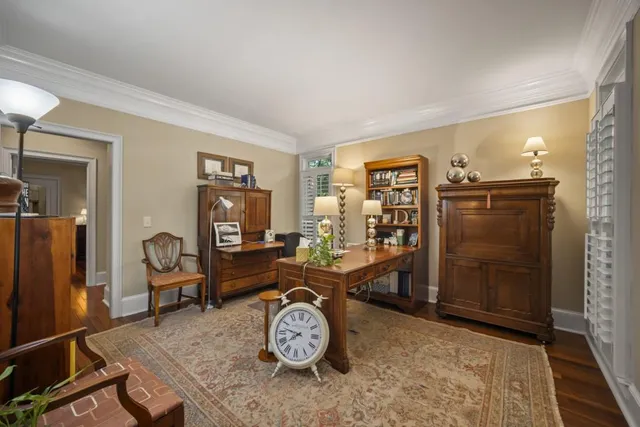 a view of a workspace with furniture and a window