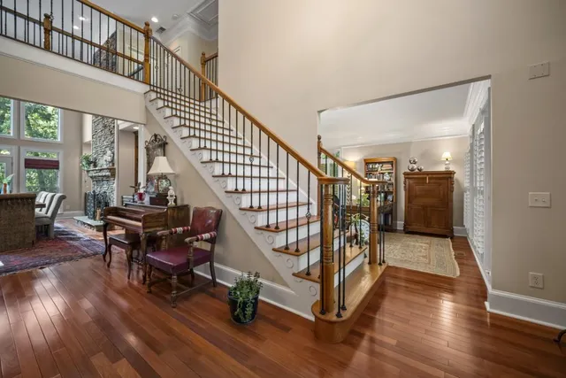 a living room with furniture a flat screen tv and a table