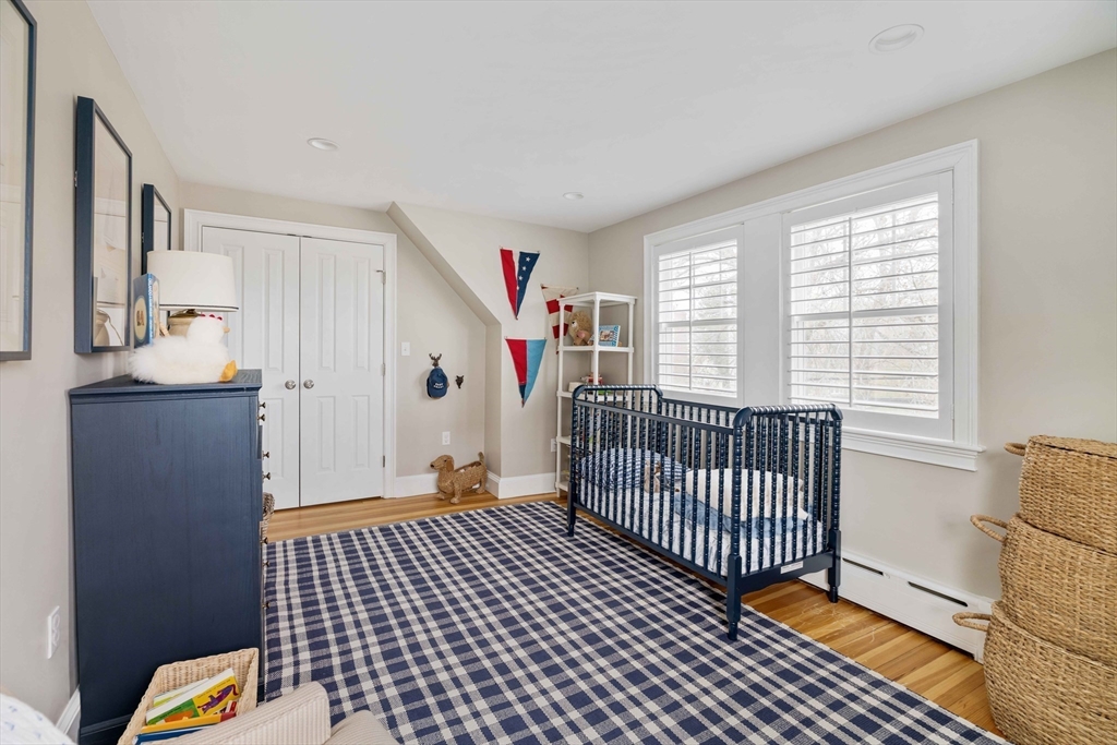 106 Florence Avenue Arlington, MA 02476 - Photo 13 of 34 a view of a bedroom with wooden floor & furniture