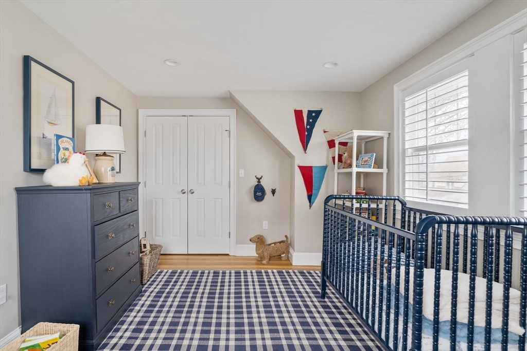 106 Florence Avenue Arlington, MA 02476 - Photo 14 of 34 a view of a bedroom with wooden floor and windows