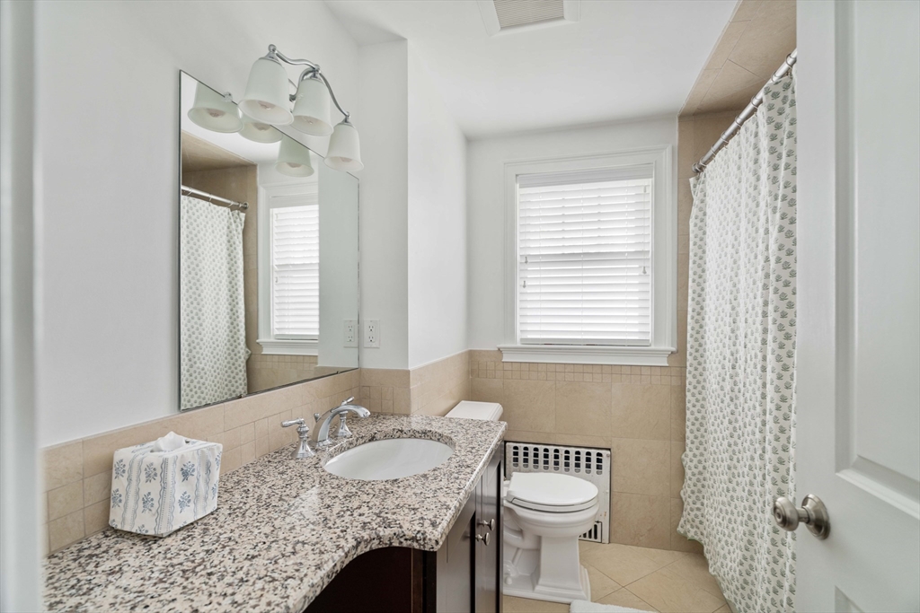 106 Florence Avenue Arlington, MA 02476 - Photo 15 of 34 a bathroom with a granite countertop sink and a mirror