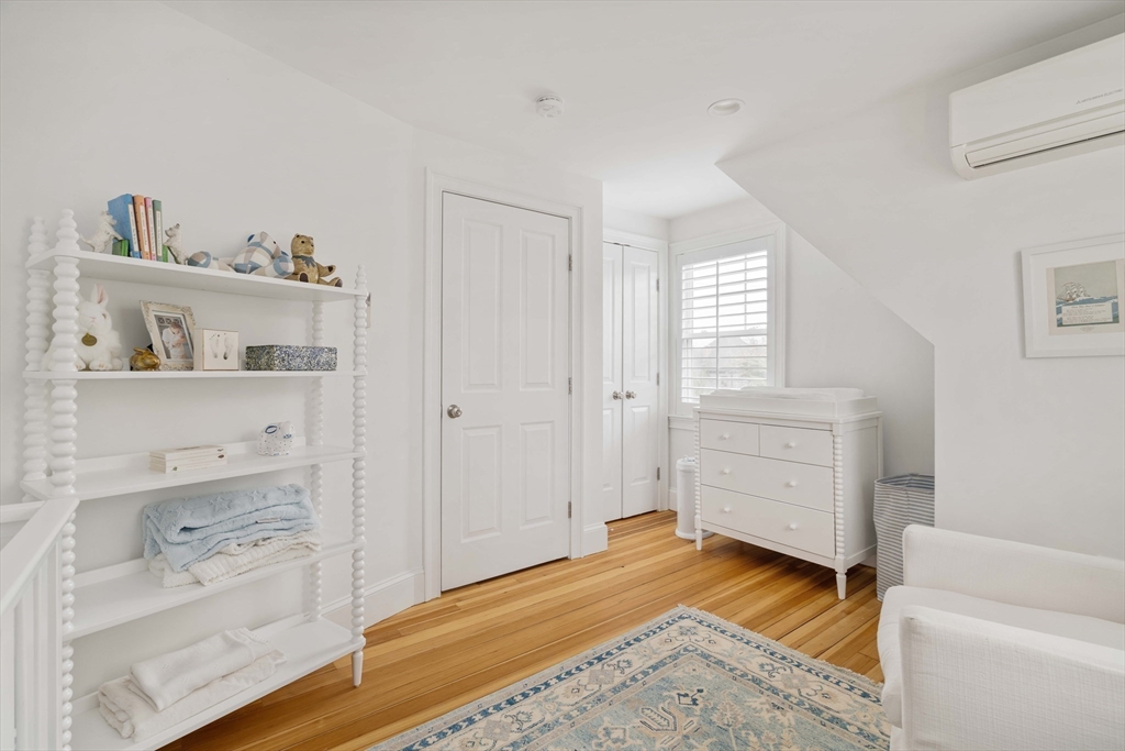 106 Florence Avenue Arlington, MA 02476 - Photo 17 of 34 a view of a bedroom with baby crib and cabinet