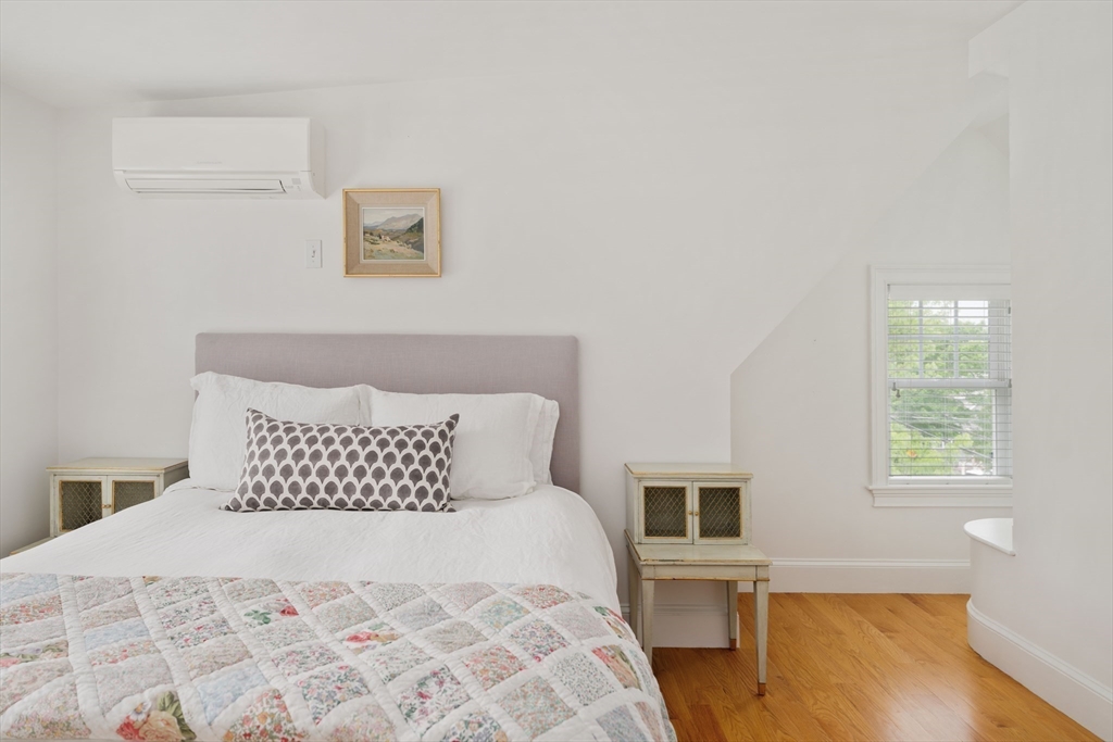 106 Florence Avenue Arlington, MA 02476 - Photo 22 of 34 a bedroom with a bed and wooden floor