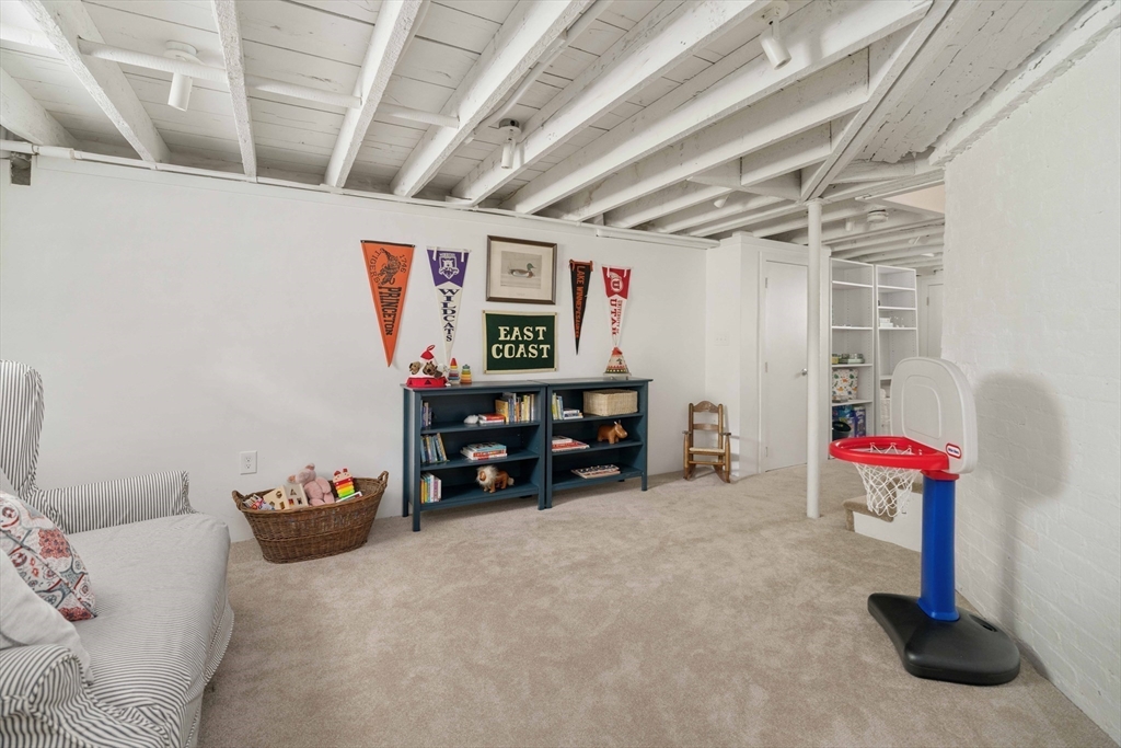 106 Florence Avenue Arlington, MA 02476 - Photo 25 of 34 a garage with a white stove and furniture