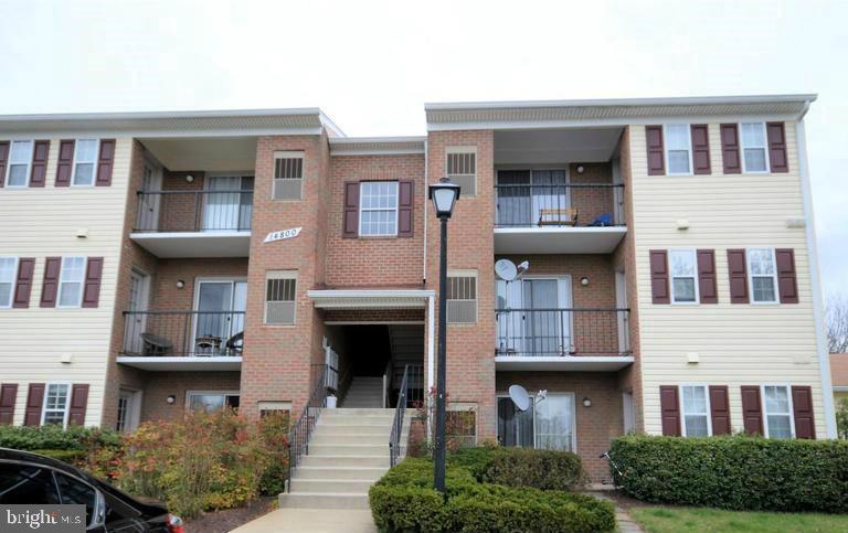 14800 Rydell Road, Unit 202 Centreville, VA 20121 - Photo 1 of 10 a front view of residential houses with yard