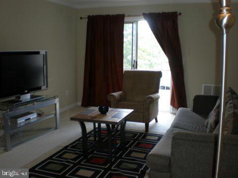 14800 Rydell Road, Unit 202 Centreville, VA 20121 - Photo 6 of 10 a living room with furniture and a flat screen tv