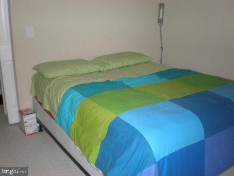 14800 Rydell Road, Unit 202 Centreville, VA 20121 - Photo 7 of 10 a bedroom with a bed and a table