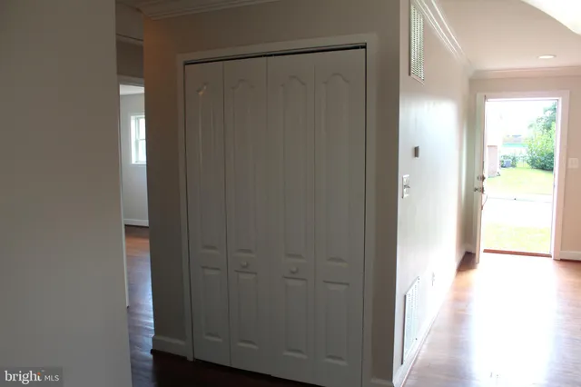 a view of a hallway with wooden floor