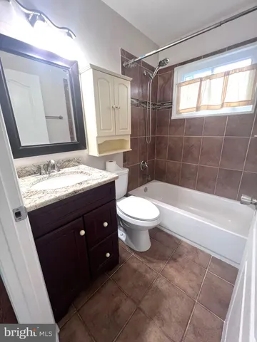 a bathroom with a sink a toilet and bathtub