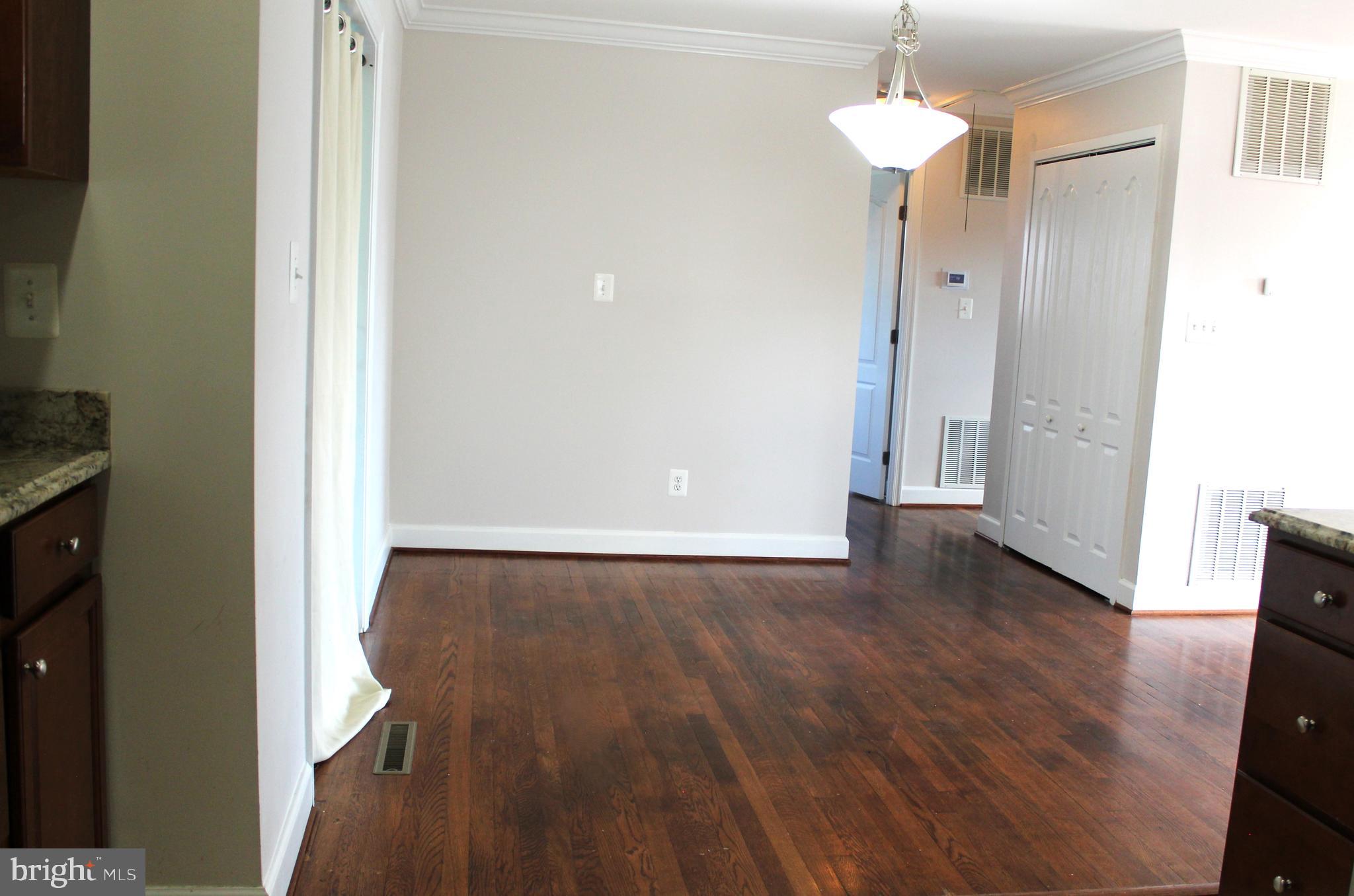 908 Vanderwood Road Catonsville, MD 21228 - Photo 18 of 36 wooden floor in an empty room with a window