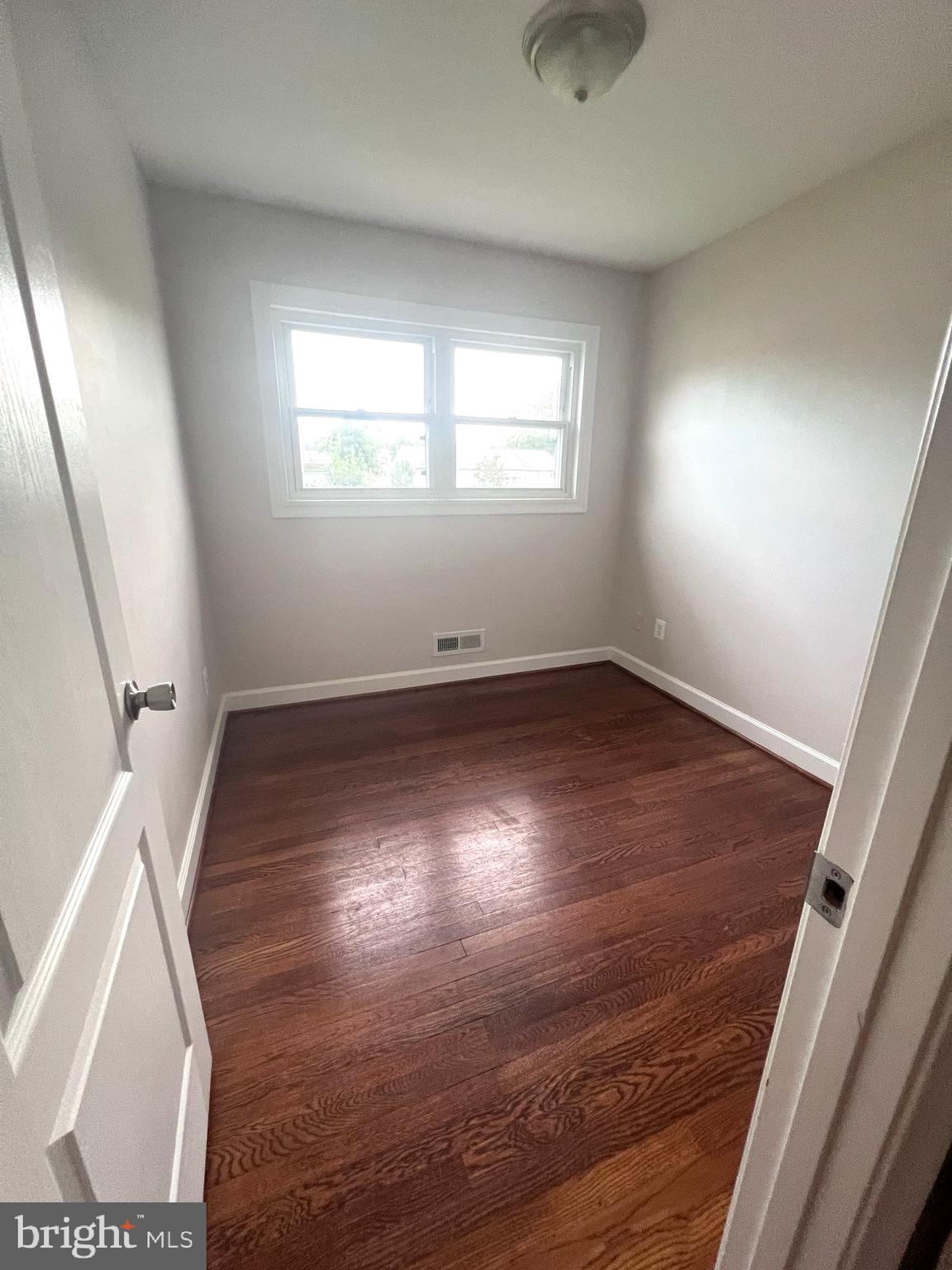 908 Vanderwood Road Catonsville, MD 21228 - Photo 23 of 36 an empty room with wooden floor and windows