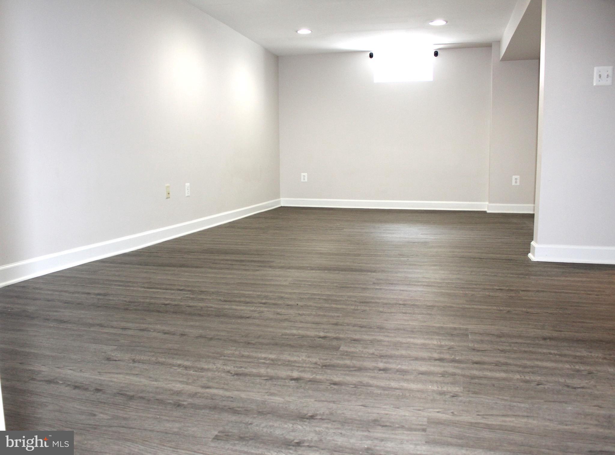 908 Vanderwood Road Catonsville, MD 21228 - Photo 27 of 36 an empty room with wooden floor and windows