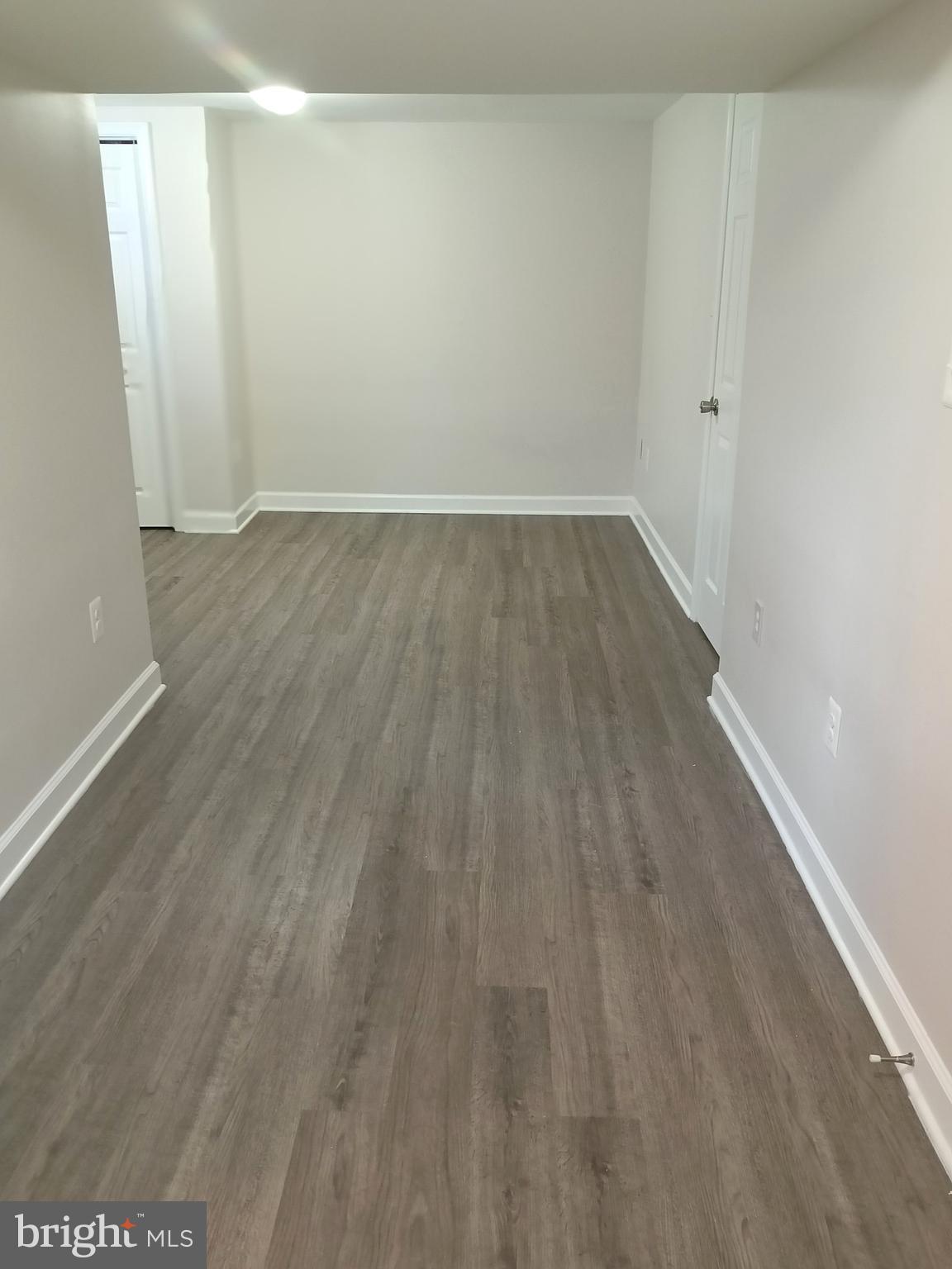 908 Vanderwood Road Catonsville, MD 21228 - Photo 29 of 36 a view of an empty room with wooden floor