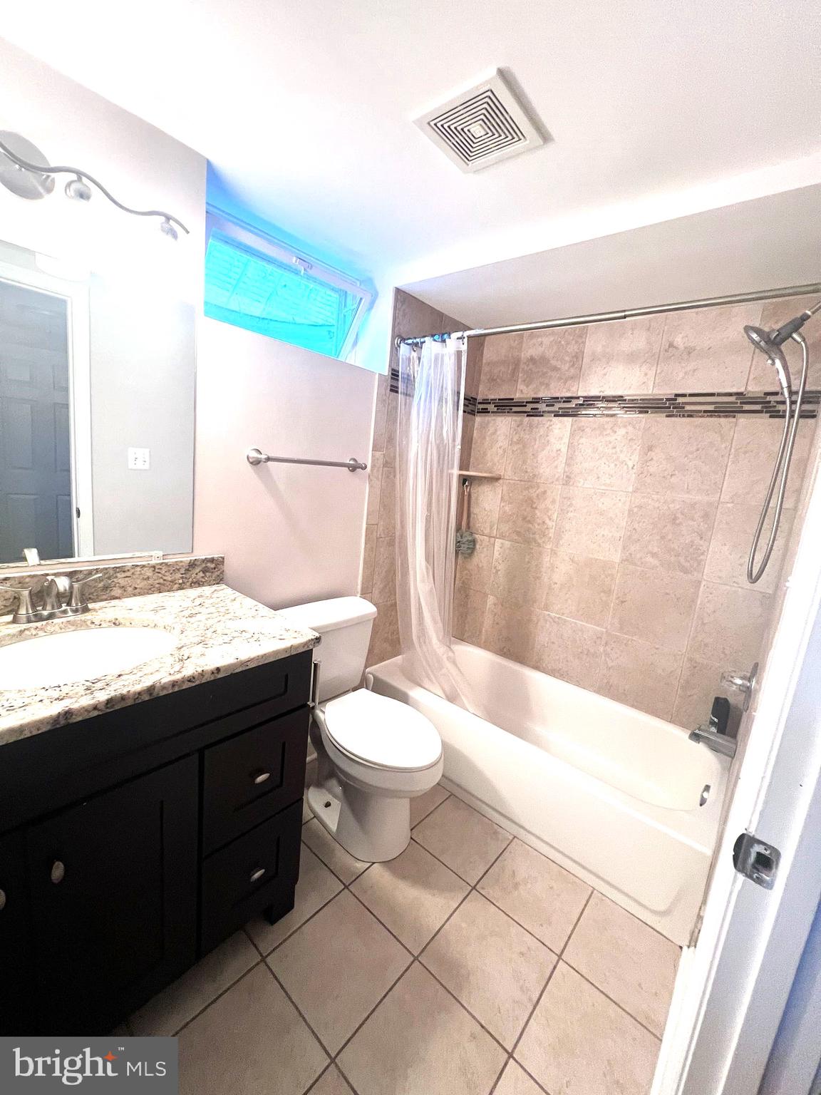 908 Vanderwood Road Catonsville, MD 21228 - Photo 30 of 36 a bathroom with a granite countertop sink a toilet a mirror and shower