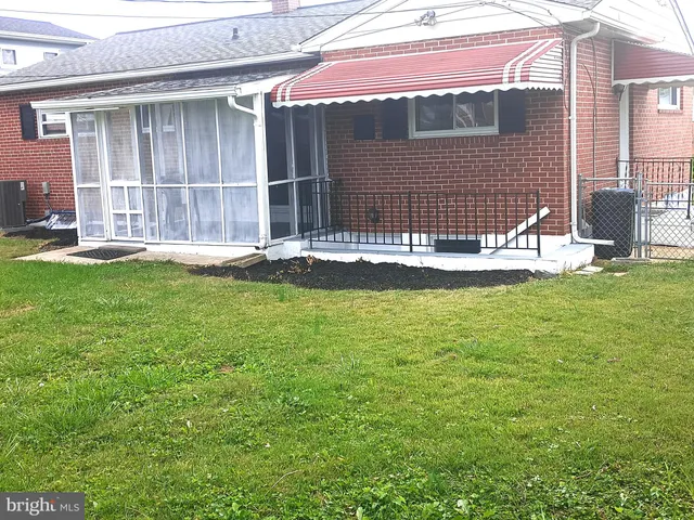 a backyard of a house with yard and porch