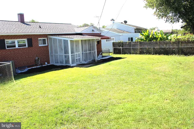 a view of a house with a backyard and a patio