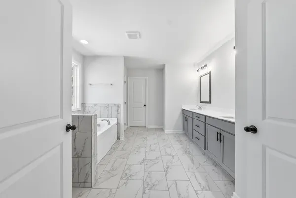 a bathroom with a bathtub and shower
