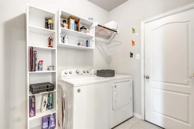 a utility room with cabinets and washer