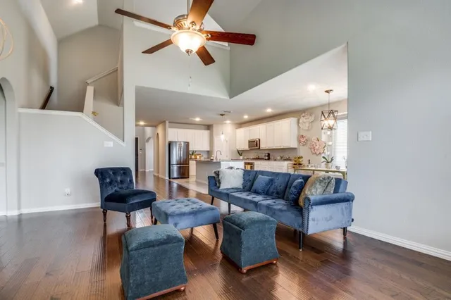 a living room with furniture and wooden floor