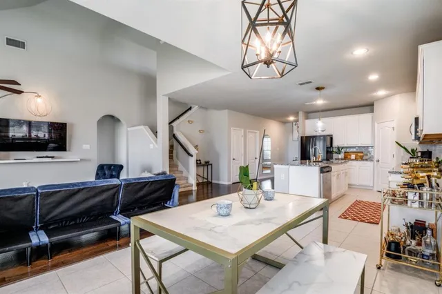 a living room with stainless steel appliances kitchen island granite countertop furniture and a kitchen view
