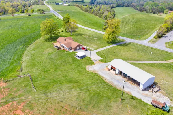 a aerial view of a house with pool and a yard