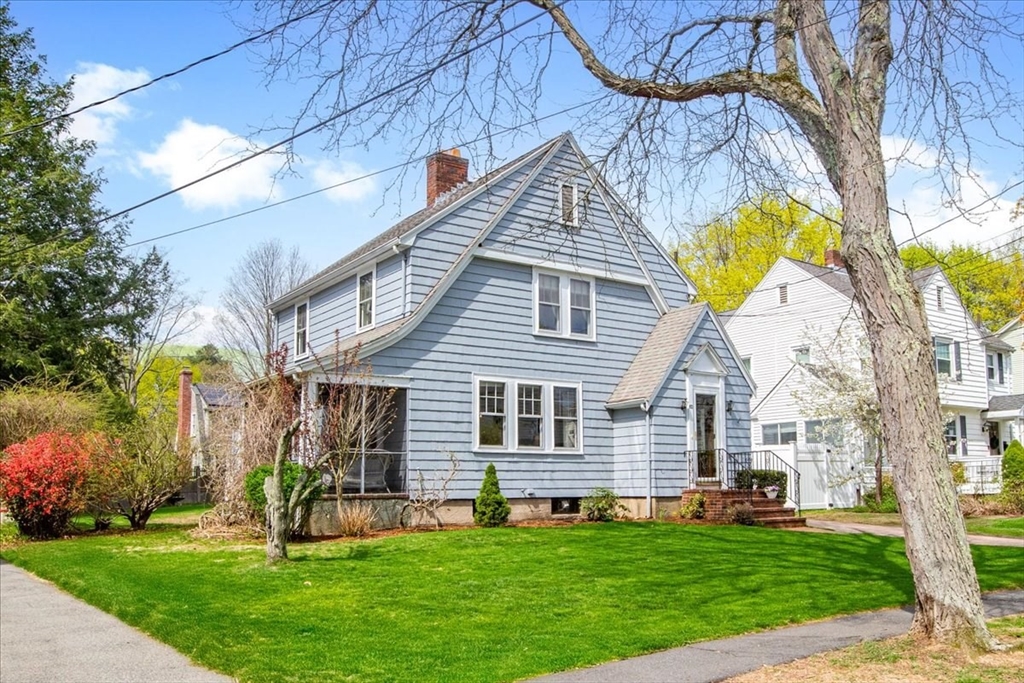 a front view of house with a garden and patio
