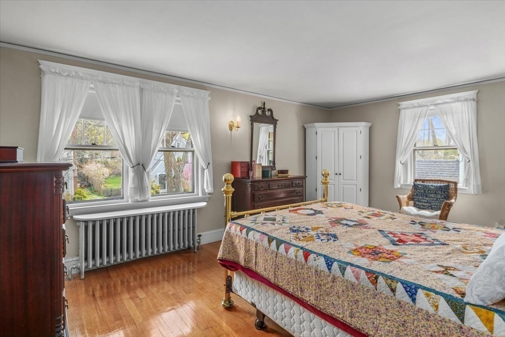 62 Washington Avenue Needham, MA 02492 - Photo 22 of 42 a bed sitting in a bedroom next to a window