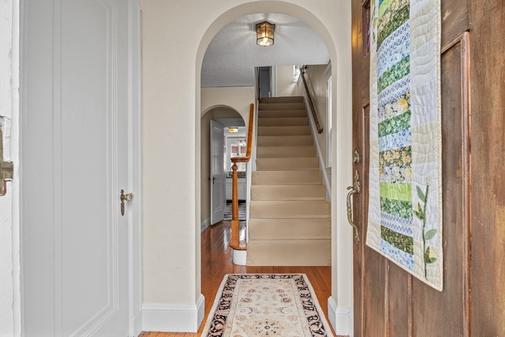 62 Washington Avenue Needham, MA 02492 - Photo 3 of 42 a view of hallway with wooden floor and a rug